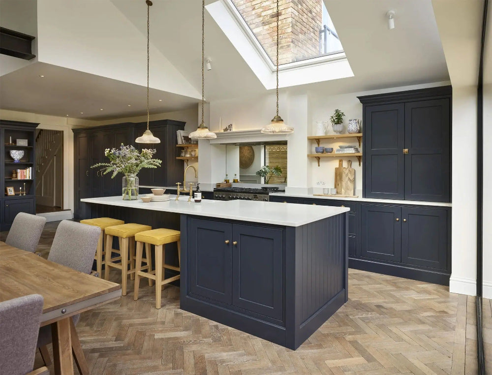Luxury kitchen in Tring with navy island and white countertops
